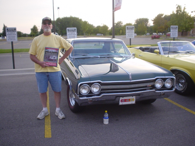 Paul Meray smiles proudly with his SF Outstanding award for his sharp Olds 442.