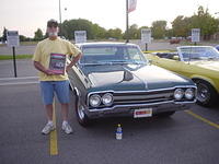 Paul Meray smiles proudly with his SF Outstanding award for his sharp Olds 442.